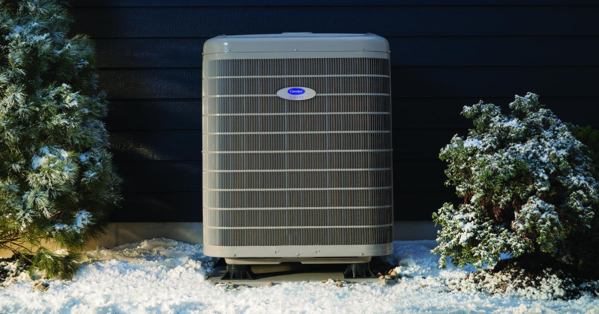 a-carrier-cold-climate-heat-pump-sits-outside-in-the-snow.jpg