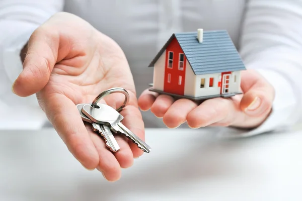 depositphotos_21515189-stock-photo-agent-with-house-model-and.jpg